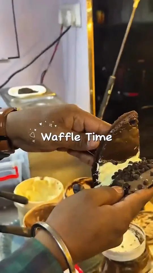 A finished waffle being loaded up at the counter