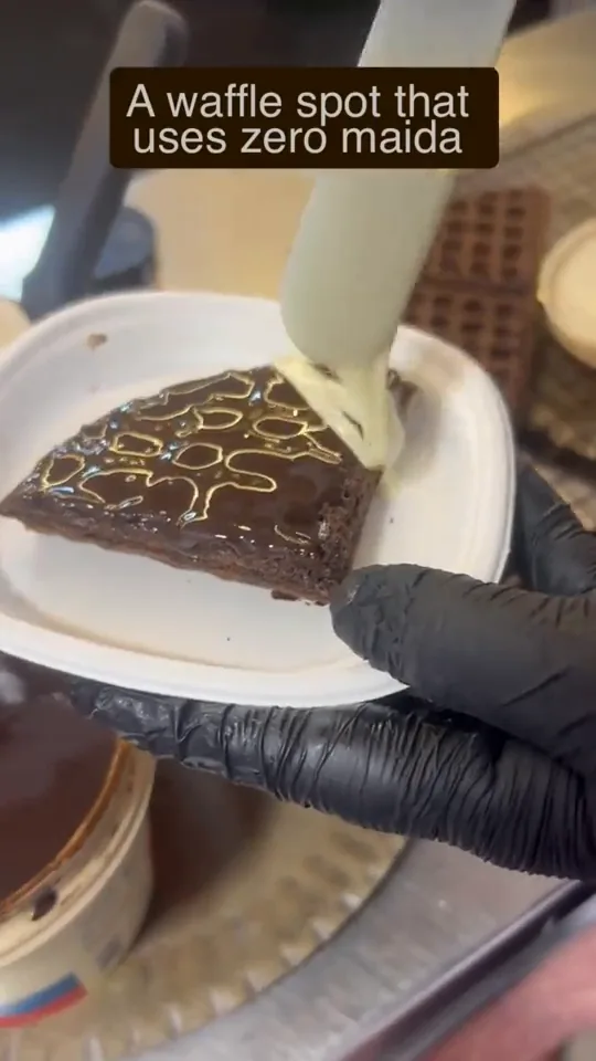 A chocolate-drizzled waffle plated at the stall